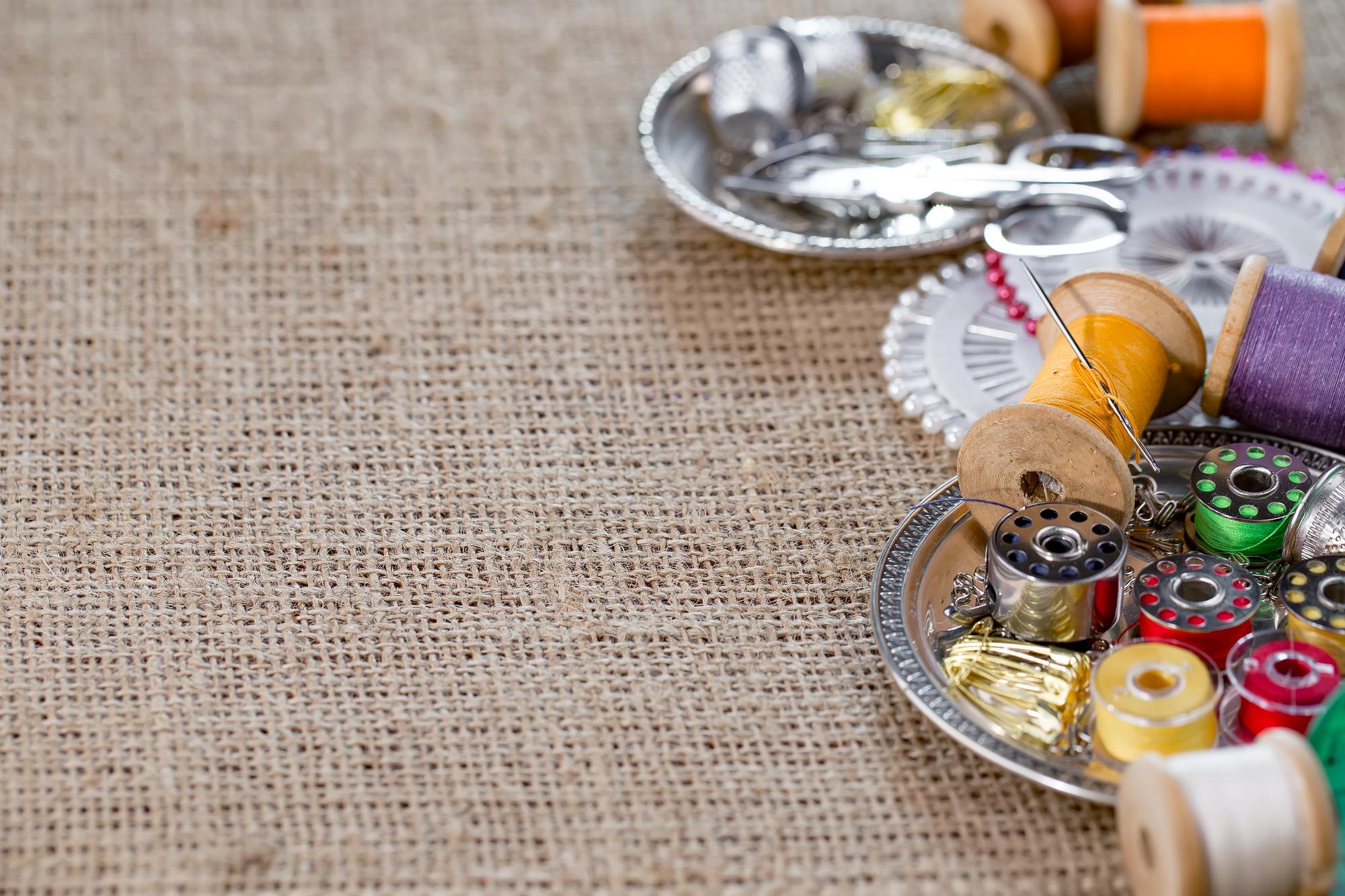 Workshop table with threads and embroidery sample